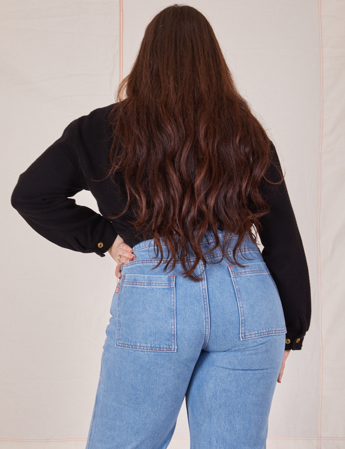 Back view of Ricky Jacket in Basic Black and light wash Sailor Jeans worn by Sydney