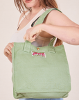 Shopper Tote Bag in Sage Green worn over shoulder on Allison