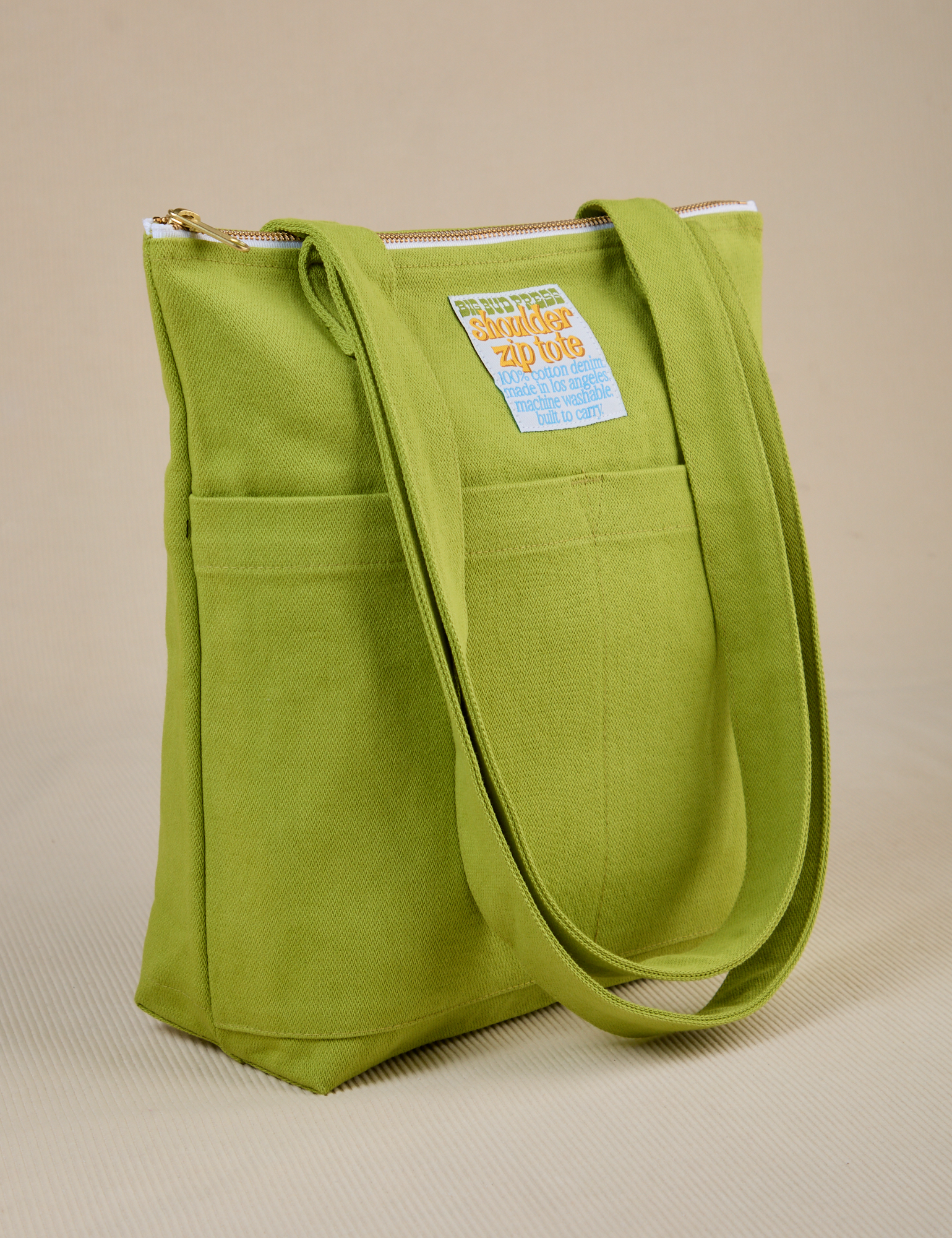 Angled view of Over-Shoulder Zip Mini Tote in Gross Green