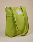 Angled view of Over-Shoulder Zip Mini Tote in Gross Green