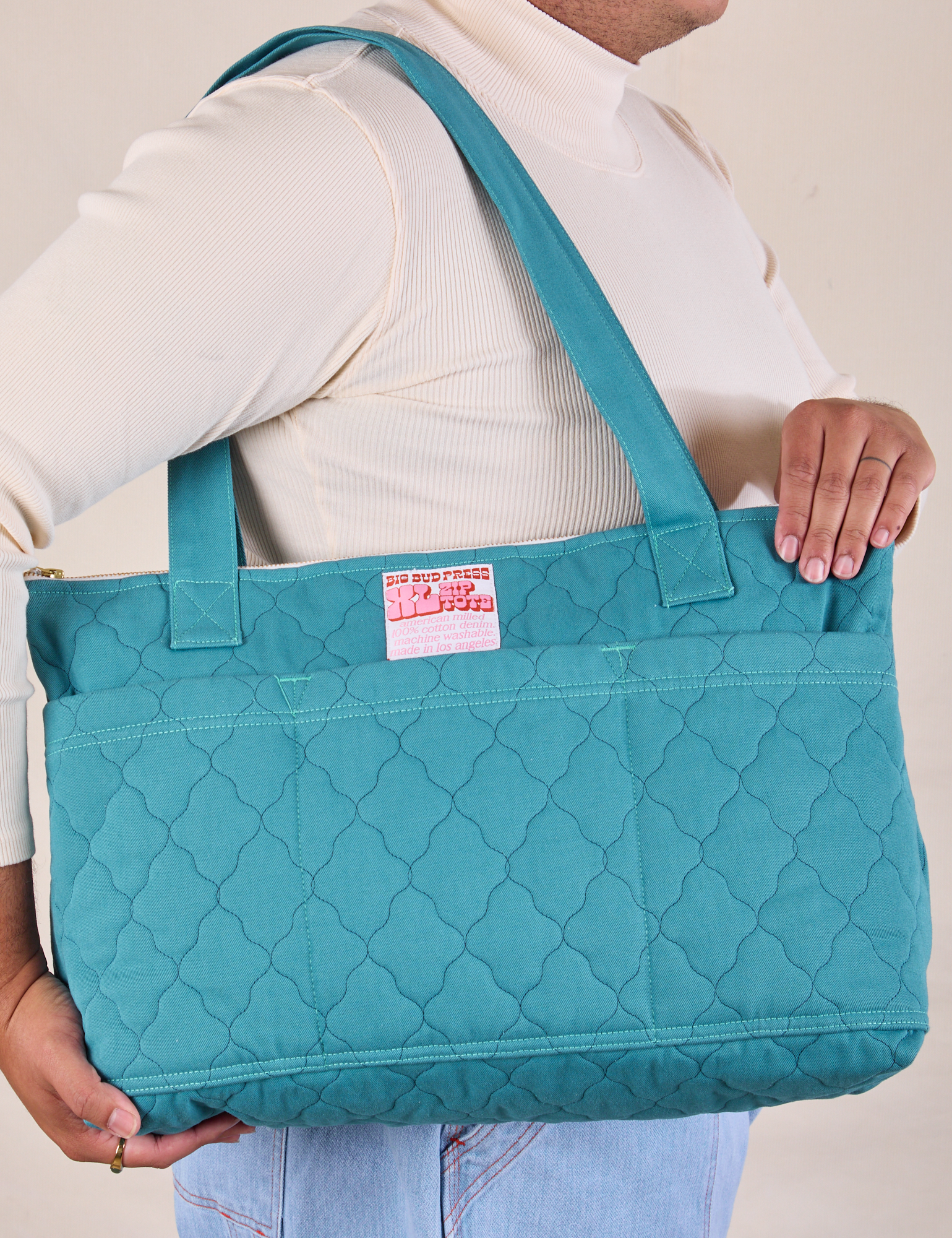 Quilted XL Tote in Marine Blue worn on model&#39;s shoulder.