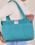 Quilted XL Tote in Marine Blue worn on model's shoulder.