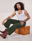 Jesse is wearing Action Pants in Swamp Green and Cropped Tank in vintage tee off-white