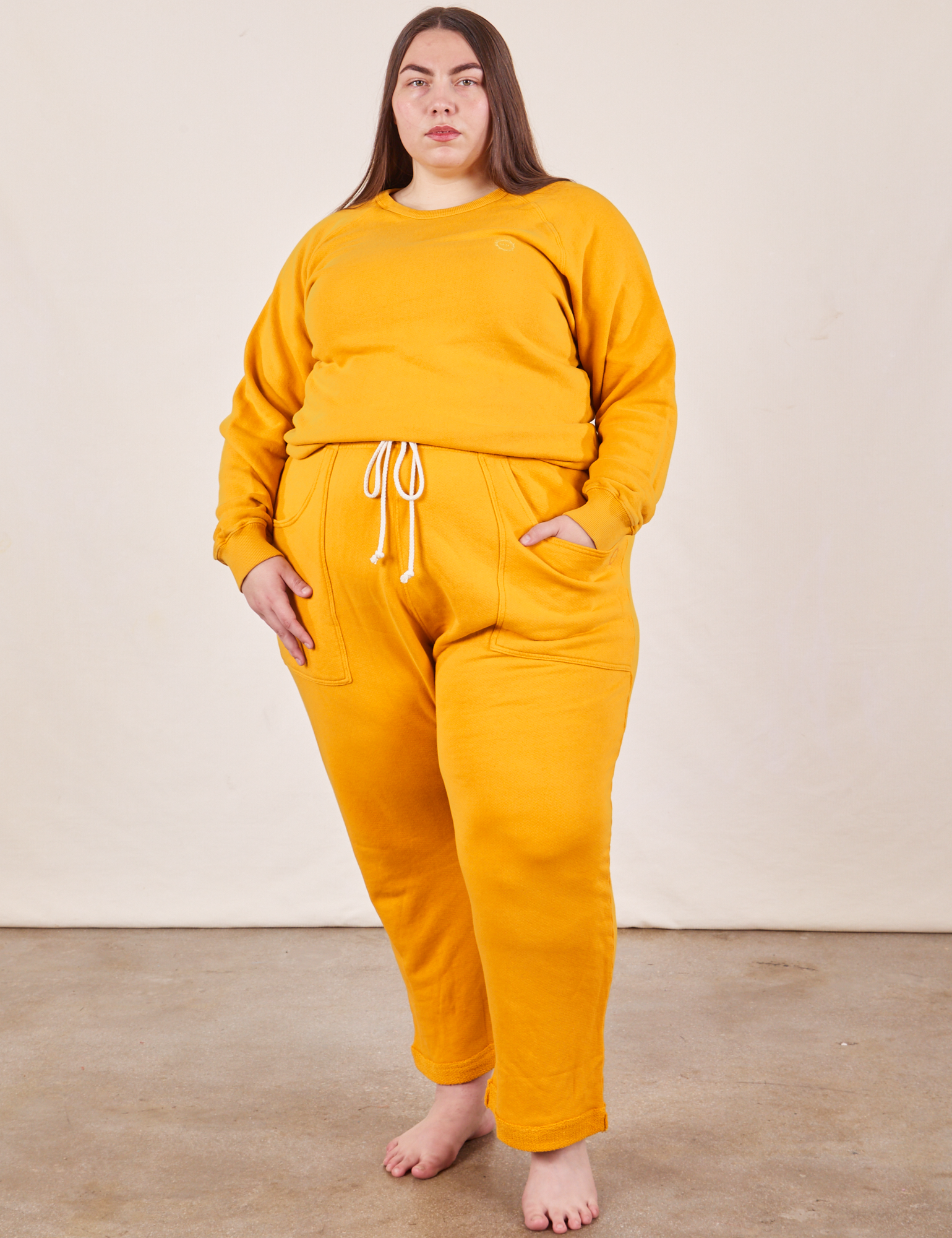 Marielena is wearing Cropped Rolled Cuff Sweatpants in Mustard Yellow and matching Heavyweight Crew Sweatshirt