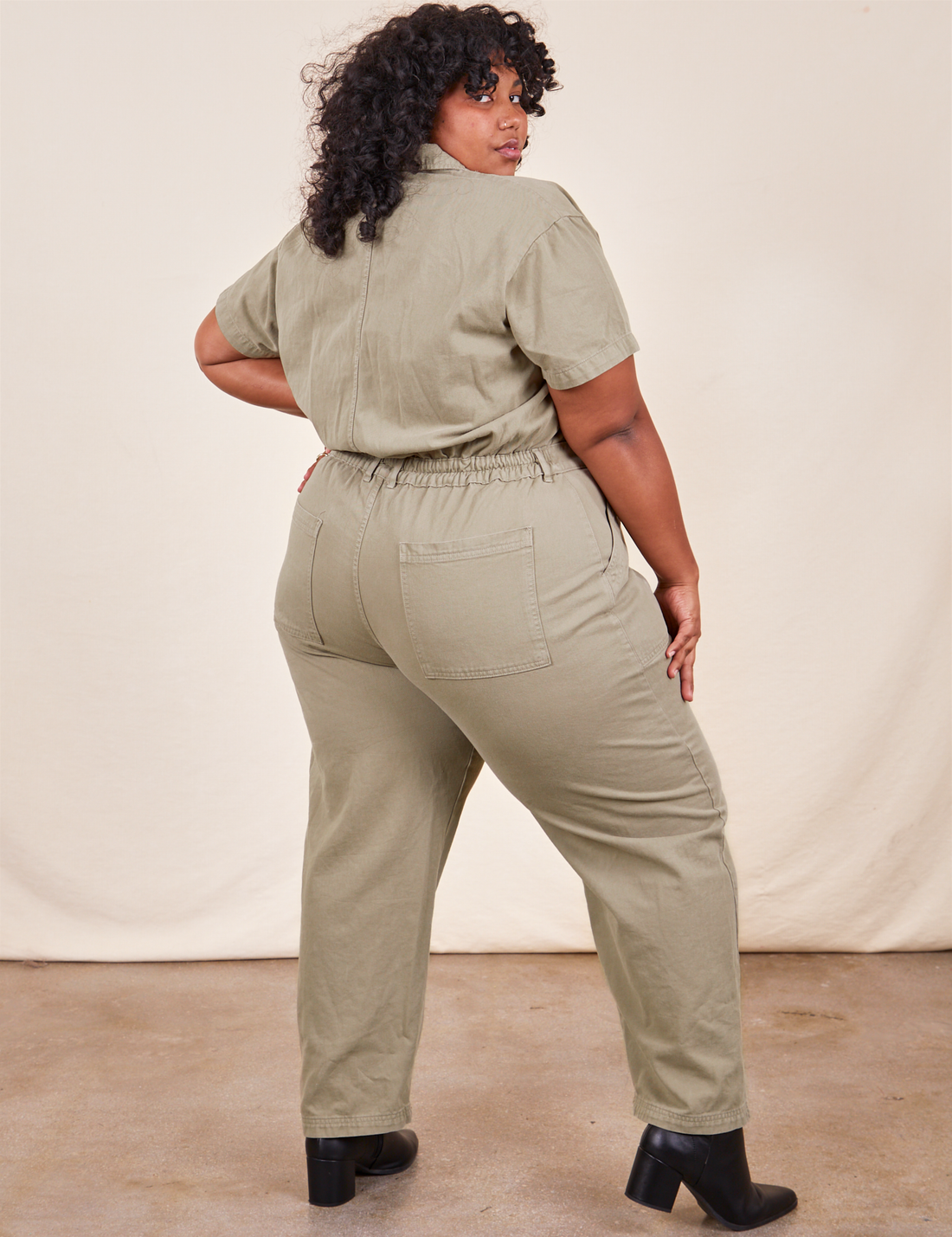 Back view of Short Sleeve Jumpsuit in Khaki Grey worn by Morgan