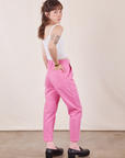 Angled back view of Petite Pencil Pants in Bubblegum Pink and vintage off-white Cropped Cami on Hana
