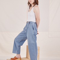 Side view of Denim Trouser Jeans in Light Wash and vintage off-white Cropped Tank Top on Hana