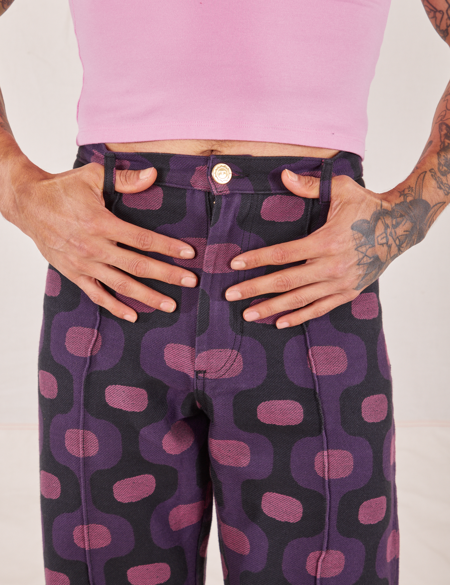 Western Pants in Purple Tile Jacquard front close up. Jesse has both thumbs through the belt loops