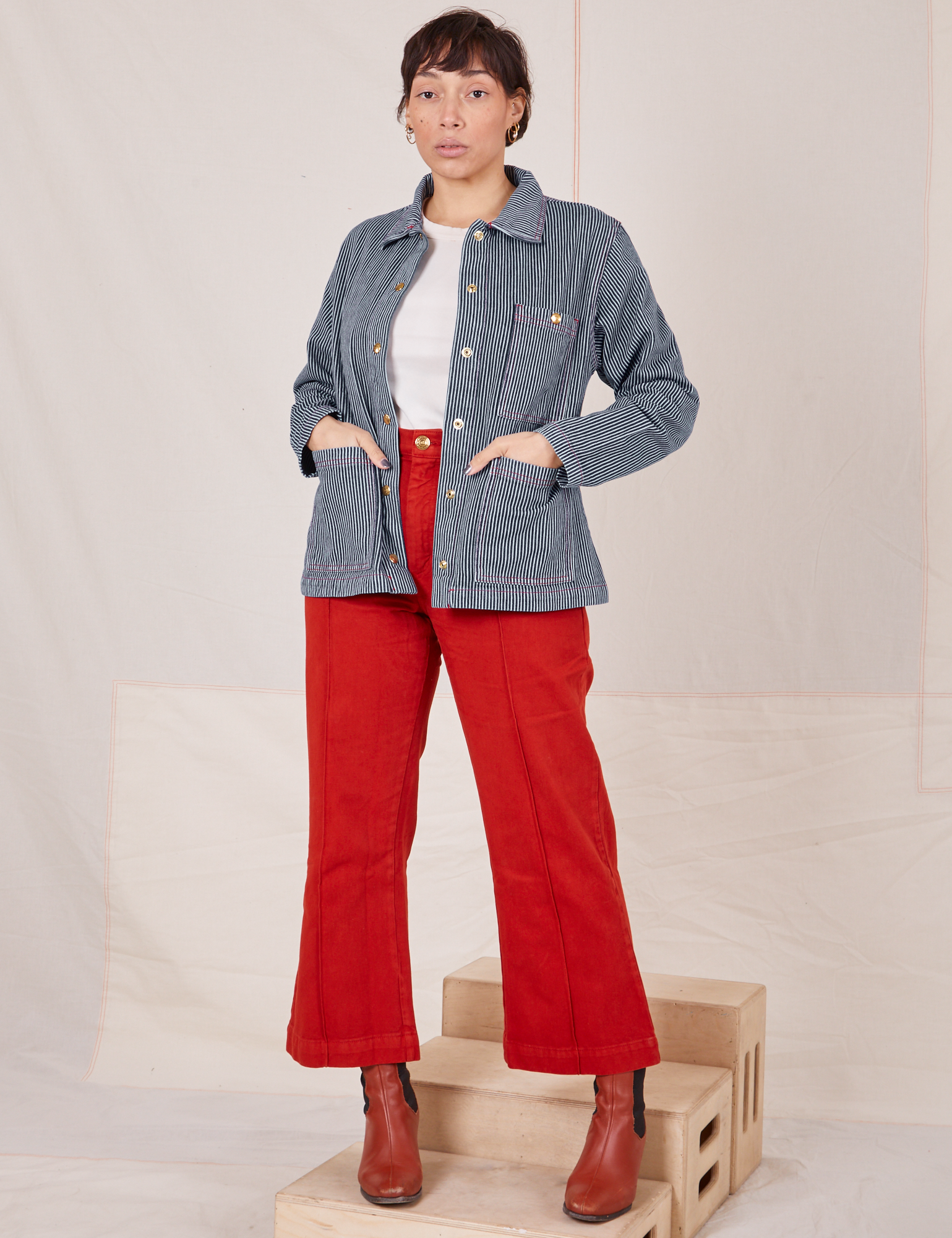 Tiara is 5&#39;4&quot; and wearing XS Railroad Stripe Denim Work Jacket paired with paprika Western Pants