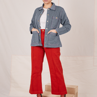Tiara is 5'4" and wearing XS Railroad Stripe Denim Work Jacket paired with paprika Western Pants