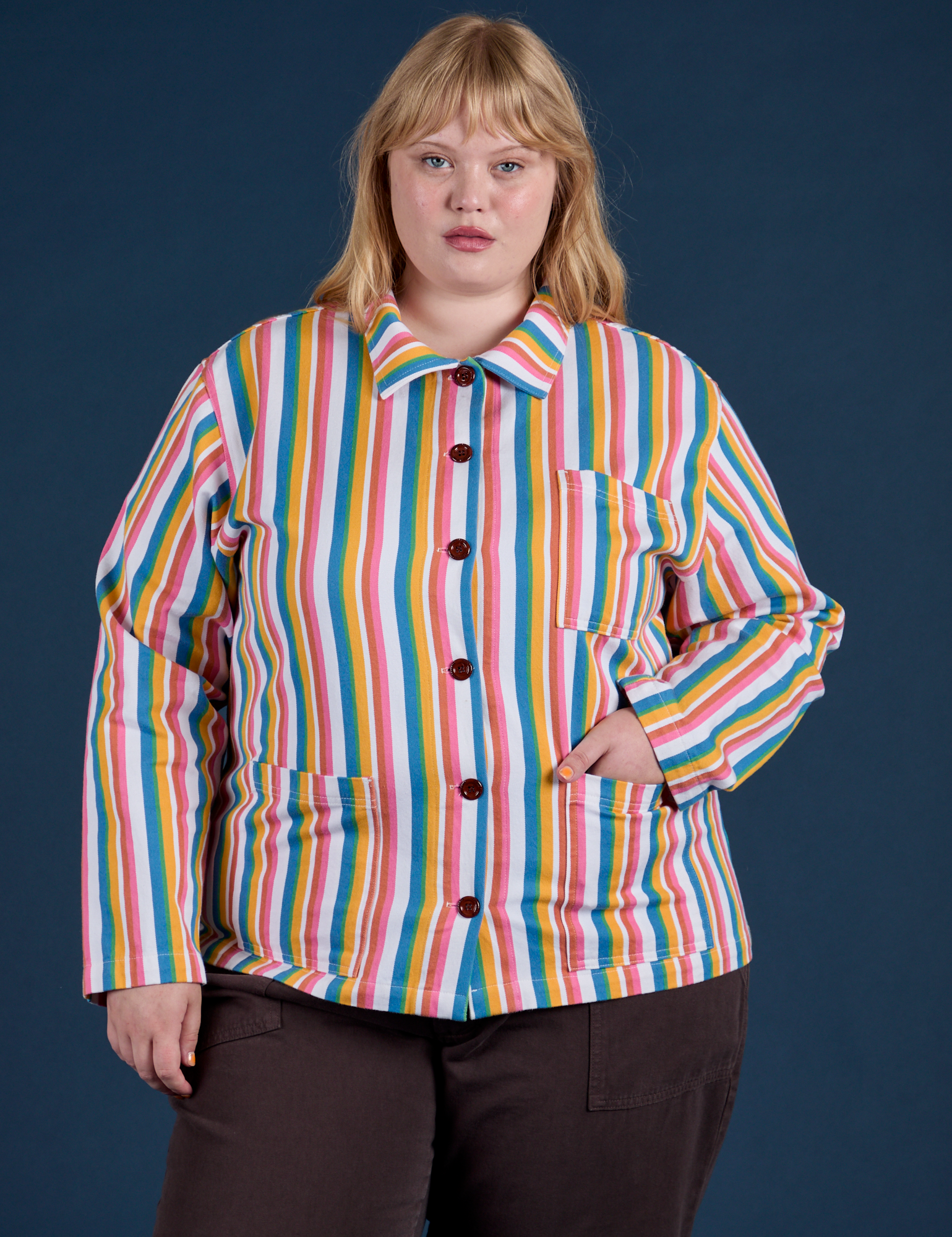 Juliet is wearing a buttoned up Stripe Work Jacket in Rainbow Stripe