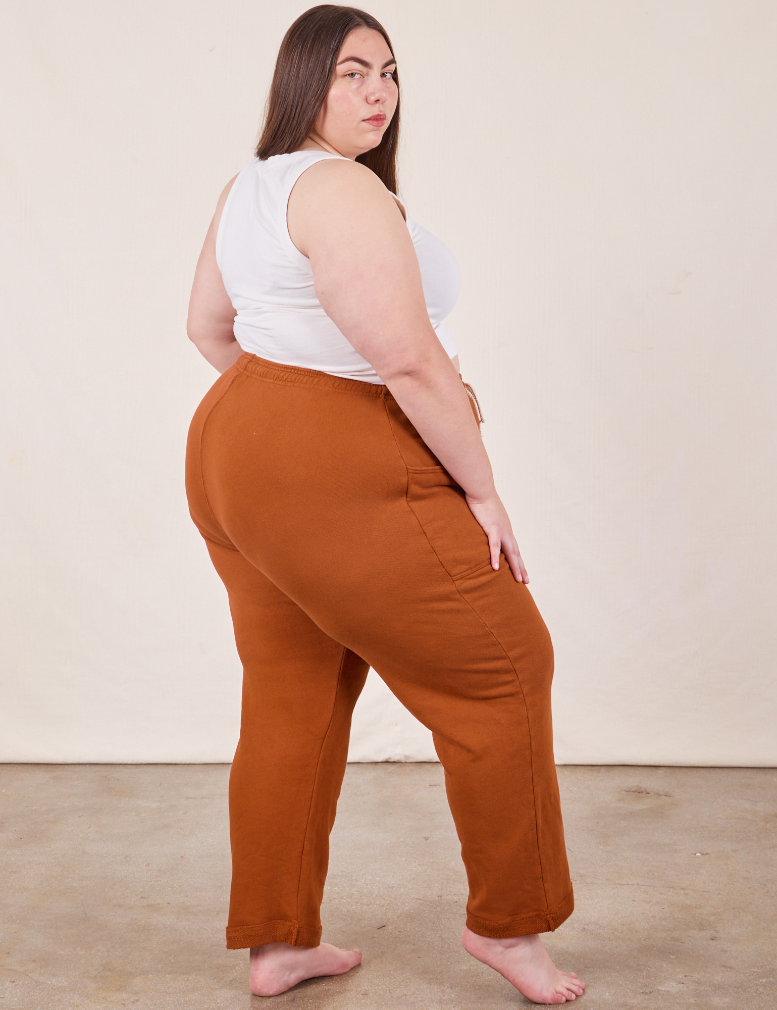 Angled back view of Cropped Rolled Cuff Sweatpants in Burnt Terracotta on Marielena