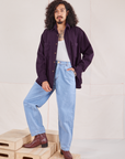 Jesse is wearing Oversize Overshirt in Nebula Purple and light wash Trouser Jeans