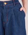 Indigo Wide Leg Trousers in Dark Wash front close up. Hana has her hand in the pocket.
