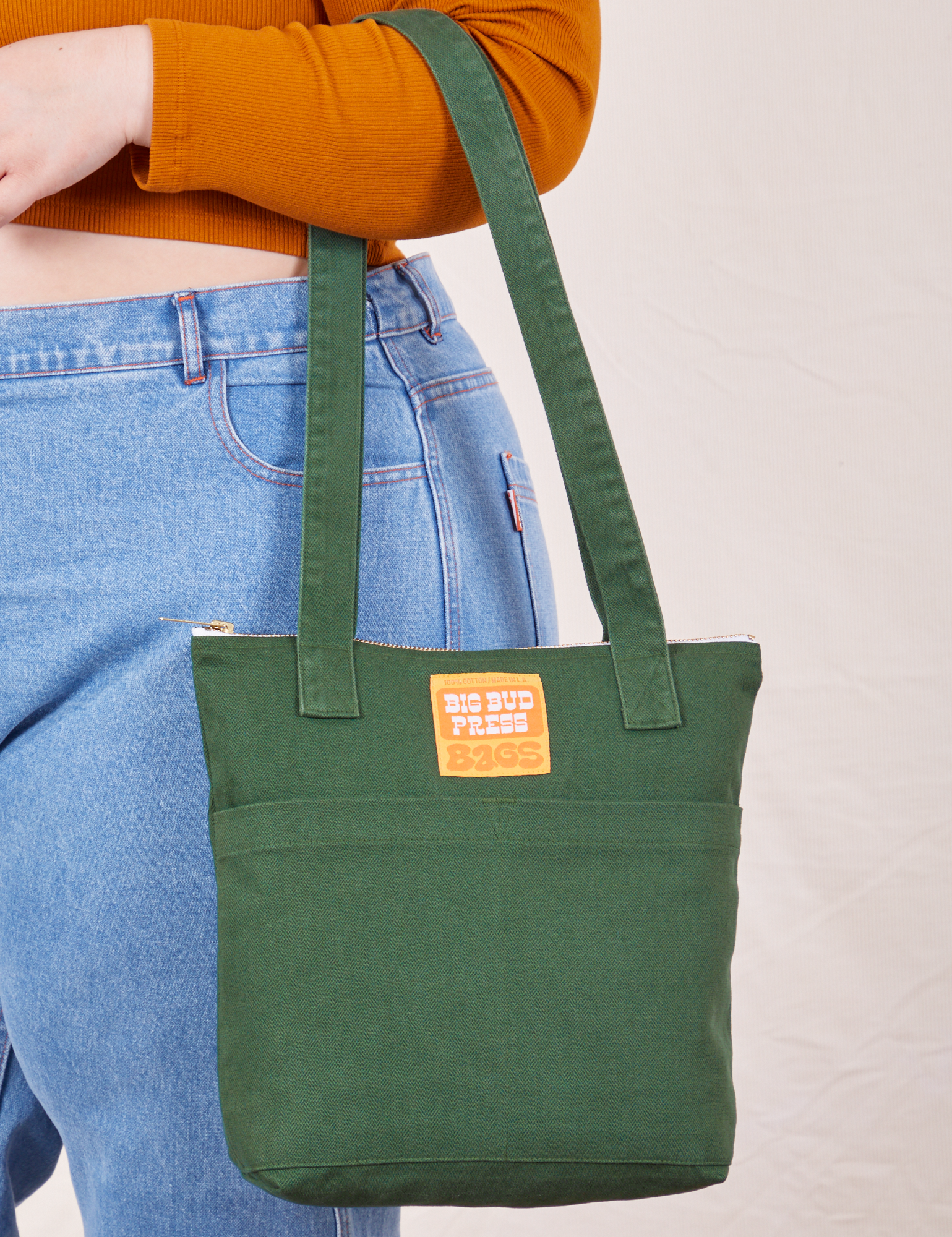 Over-Shoulder Zip Mini Tote in Dark Emerald Green worn on model&#39;s arm