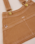 Overall Handbag in Tan. White contrast stitching. Brass sun baby buttons and hardware.