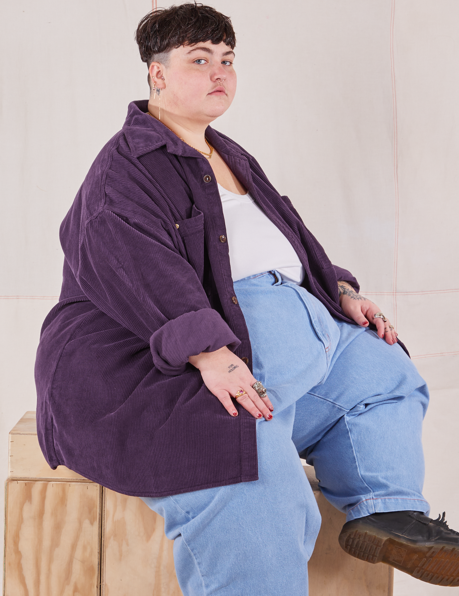 Jordan is wearing Corduroy Overshirt in Nebula Purple with a vintage off-white Cropped Tank Top underneath paired with light wash Denim Trouser Jeans