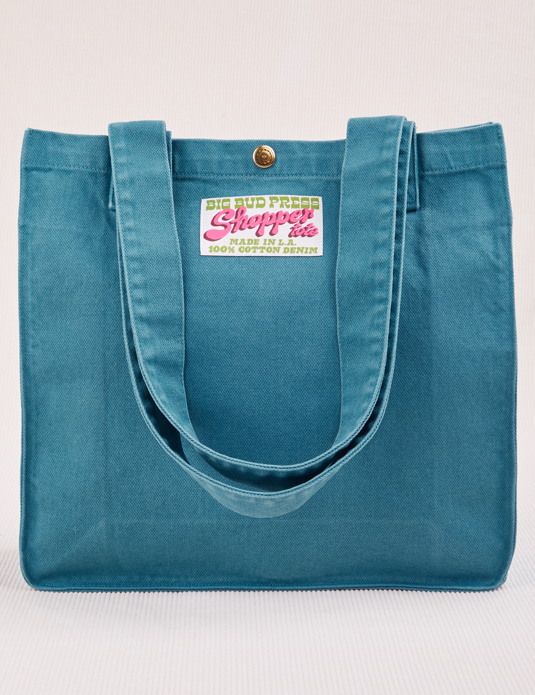 Shopper Tote Bag in Marine Blue with straps hanging down front of bag