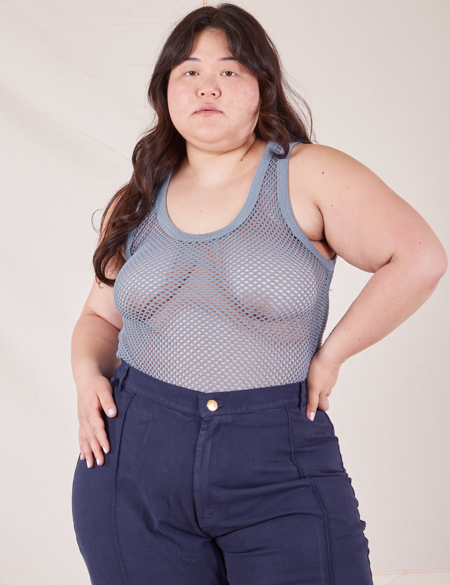 Ashley is 5'7" and wearing L Mesh Tank Top in Periwinkle paired with navy Western Pants