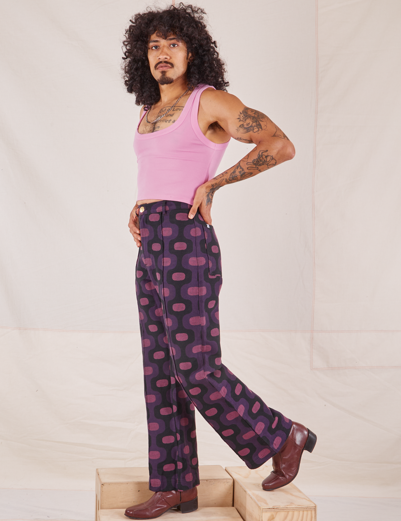 Side view of Western Pants in Purple Tile Jacquard and bubblegum pink Cropped Tank Top on Jesse