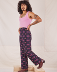 Side view of Western Pants in Purple Tile Jacquard and bubblegum pink Cropped Tank Top on Jesse