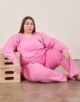 Marielena is wearing Cropped Rolled Cuff Sweatpants in Bubblegum Pink and matching Heavyweight Crew Sweatshirt