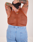 Back view of Mesh Tank Top in Burnt Terracotta and light wash Sailor Jeans worn by Sam