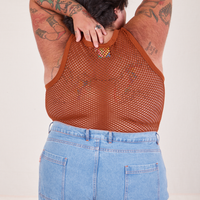 Back view of Mesh Tank Top in Burnt Terracotta and light wash Sailor Jeans worn by Sam