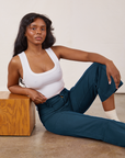 Kandia is wearing Petite Western Pants in Lagoon and vintage tee off-white Cropped Tank
