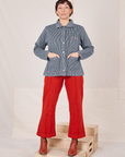 Railroad Stripe Denim Work Jacket and paprika Western Pants worn by Tiara. Jacket is buttoned up and Tiara has her hands in both front pockets