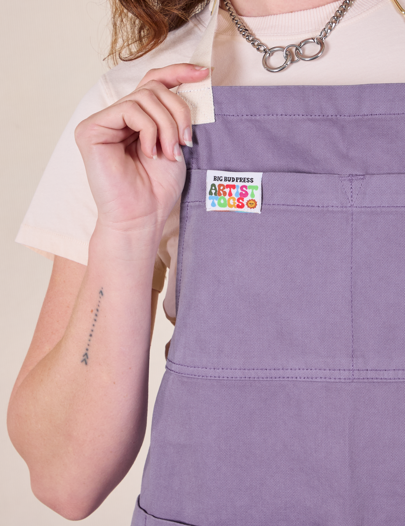 Full Denim Apron in Faded Grape front close up on Alex