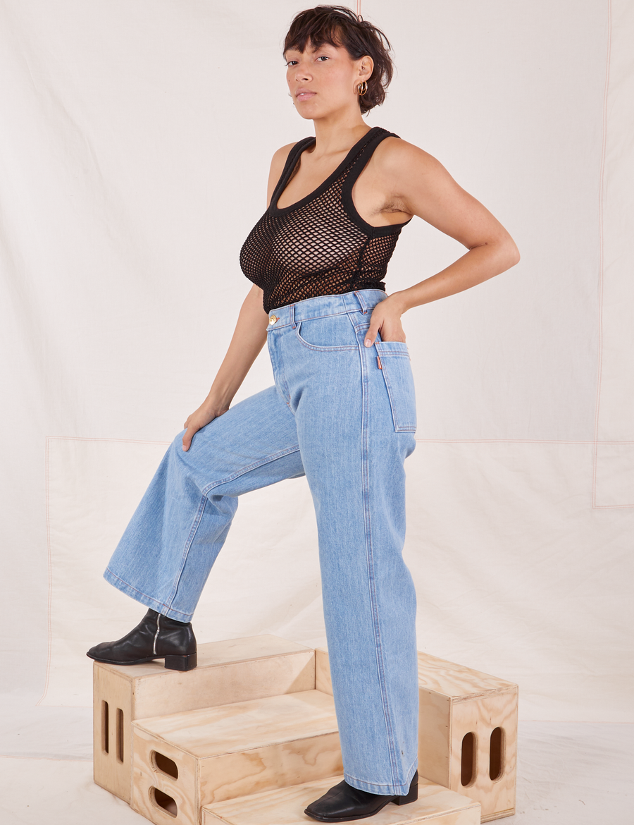 Side view of Mesh Tank Top in Basic Black and light wash Sailor Jeans worn by Tiara.