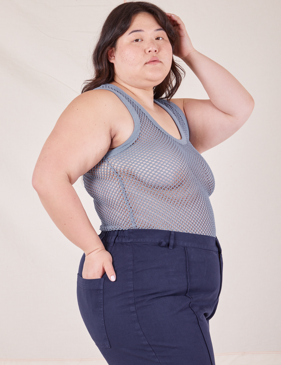 Side view of Ashley wearing Mesh Tank Top in Periwinkle and navy Western Pants