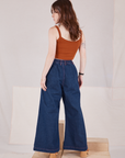 Back view of Indigo Wide Leg Trousers in Dark Wash and burnt terracotta Cropped Cami on Hana