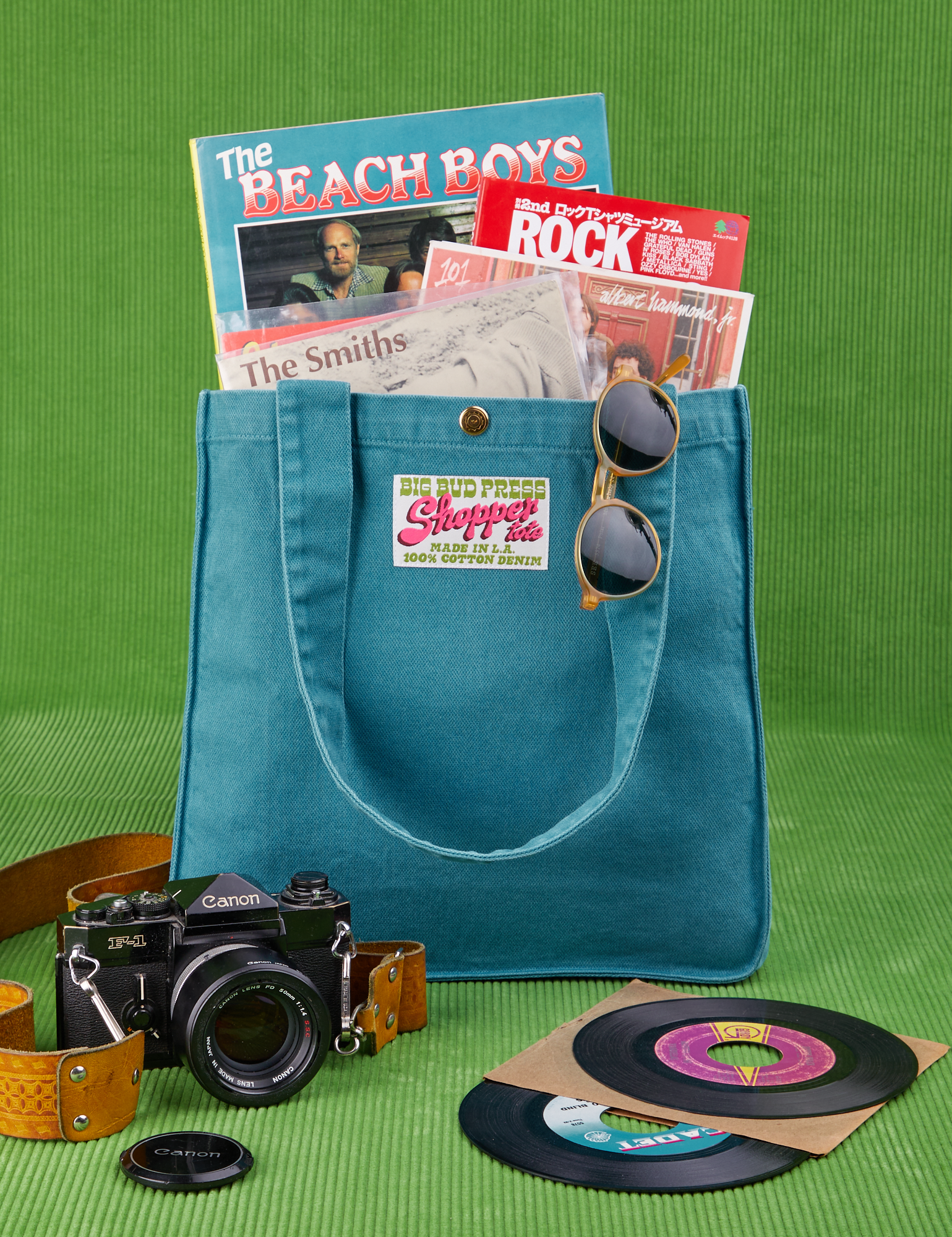 Shopper Tote Bag in Marine Blue with records and books inside. Camera sits in front of bag.