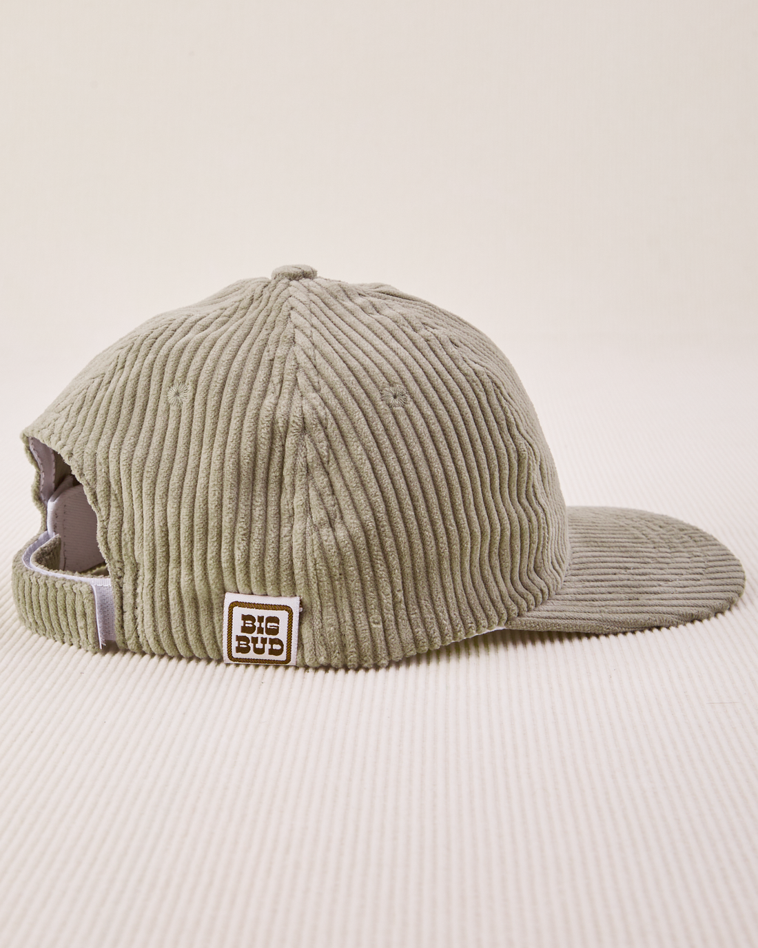 Side view Dugout Corduroy Hat in Khaki Grey. Big Bud label sewn on edge of hat.