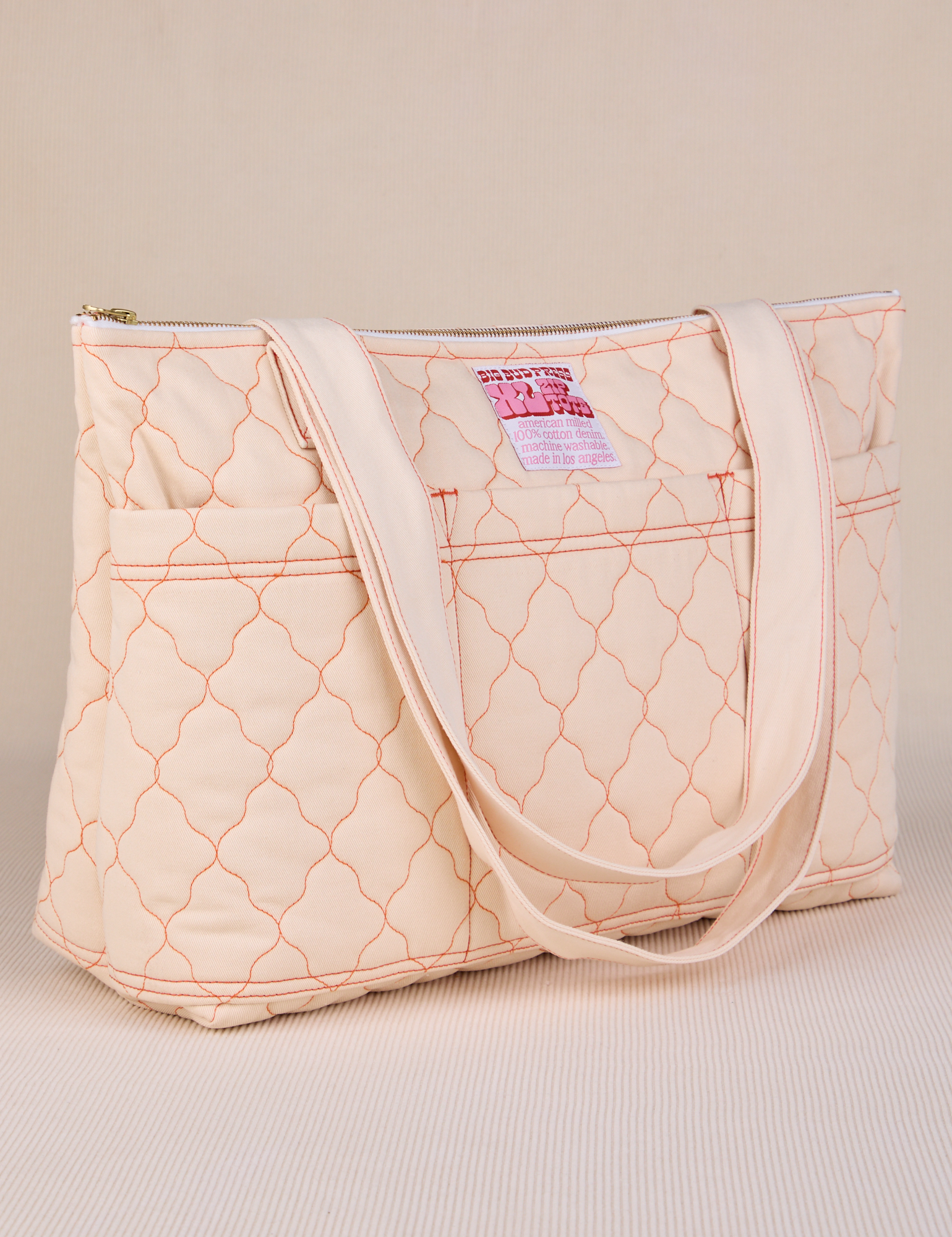 Angled view of Quilted XL Tote in vintage tee off-white