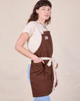 Side view of Full Denim Apron in Fudgesicle Brown on Alex