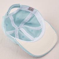 Dugout Corduroy Hat in Baby Blue flipped over. White satin under-bill.