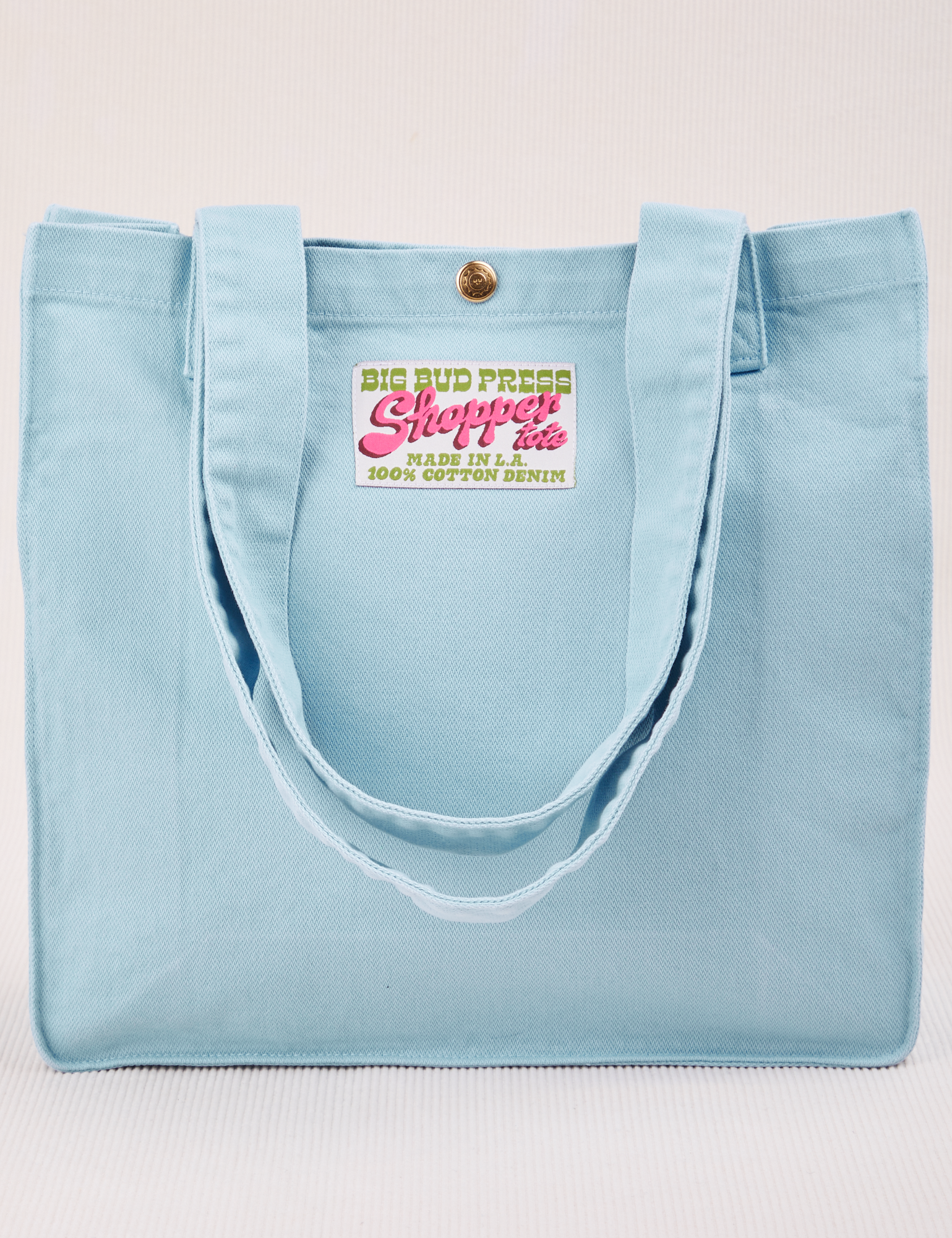 Shopper Tote Bag in Baby Blue with straps hanging down front of bag