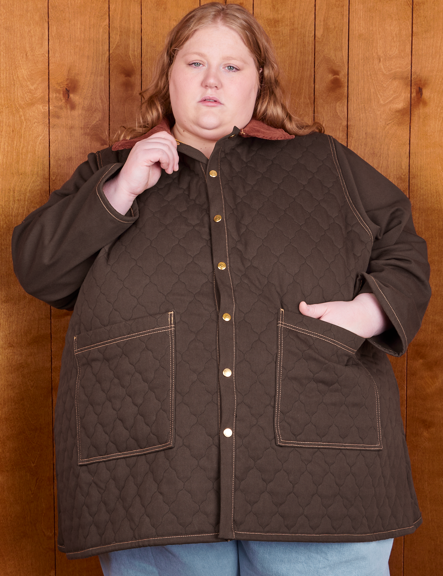 Catie is wearing a buttoned up Quilted Overcoat in Espresso Brown