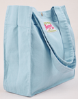 Angled view of Shopper Tote Bag in Baby Blue