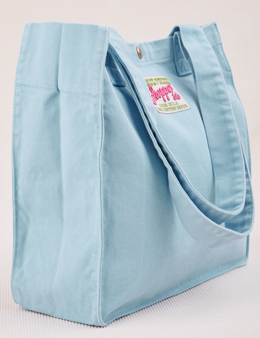 Angled view of Shopper Tote Bag in Baby Blue