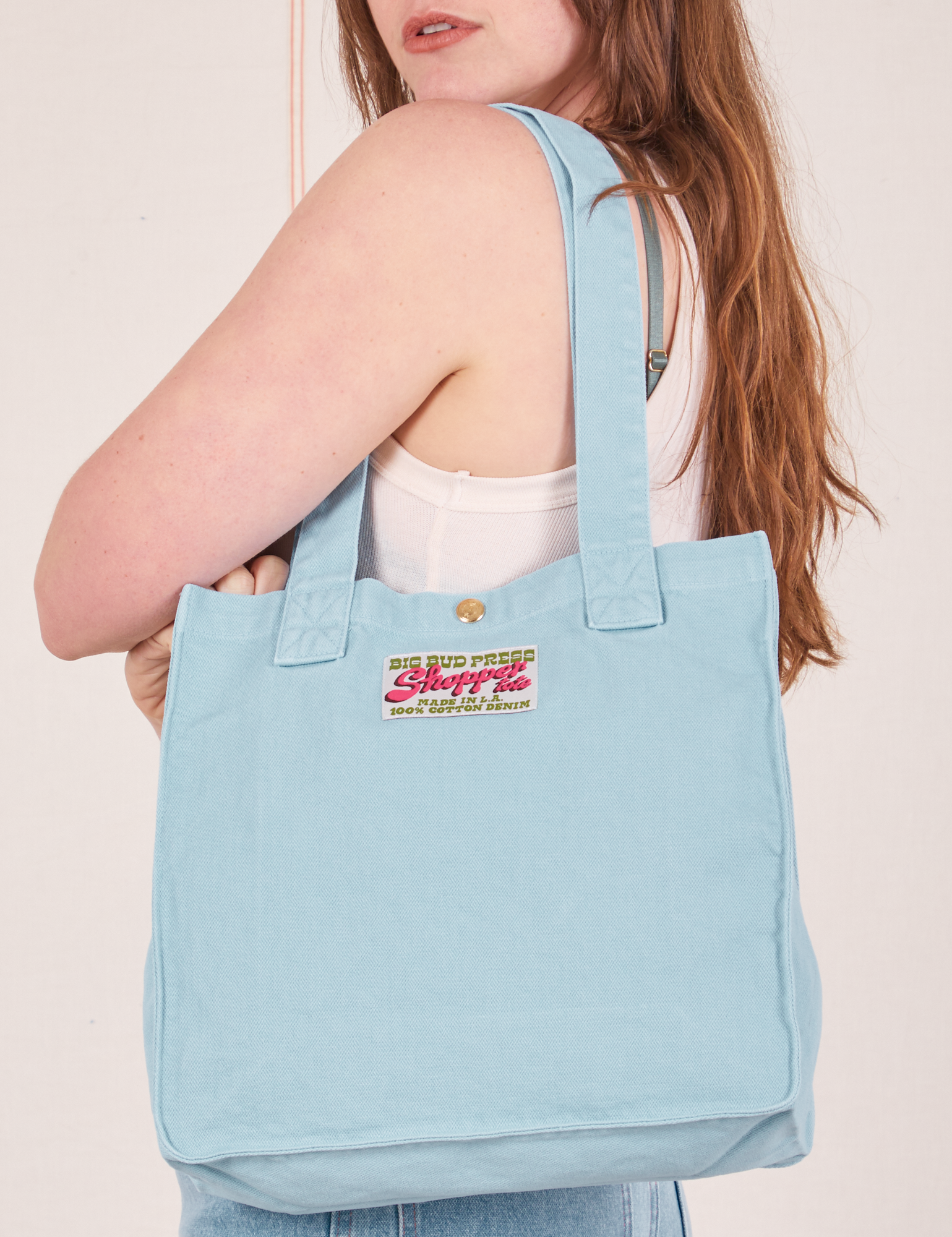 Shopper Tote Bag in Baby Blue worn over shoulder on Allison