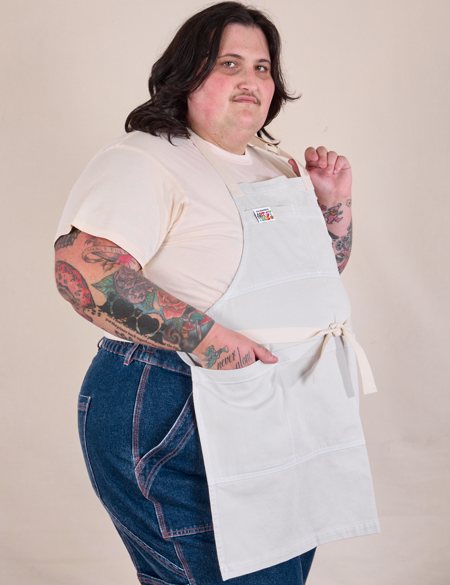 Side view of Full Denim Apron in Stone White on Sam