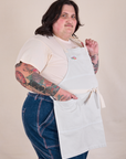 Side view of Full Denim Apron in Stone White on Sam