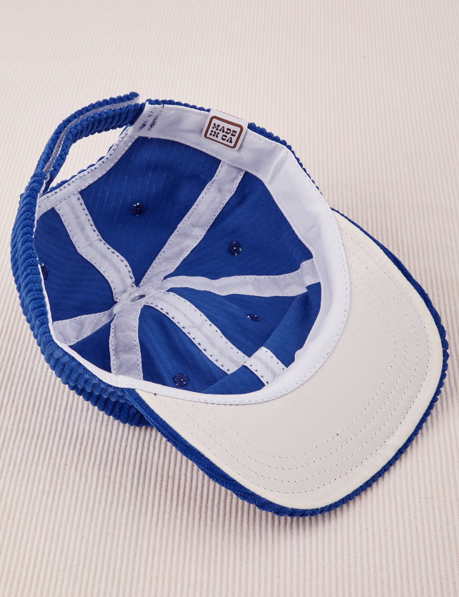 Dugout Corduroy Hat in Royal Blue flipped over. White satin under-bill