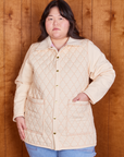 Ashley is wearing a buttoned up Quilted Overcoat in Vintage Off-White