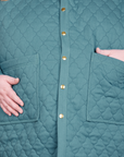 Front close up of Quilted Overcoat in Marine Blue on Catie. She has her hand in the front pocket.