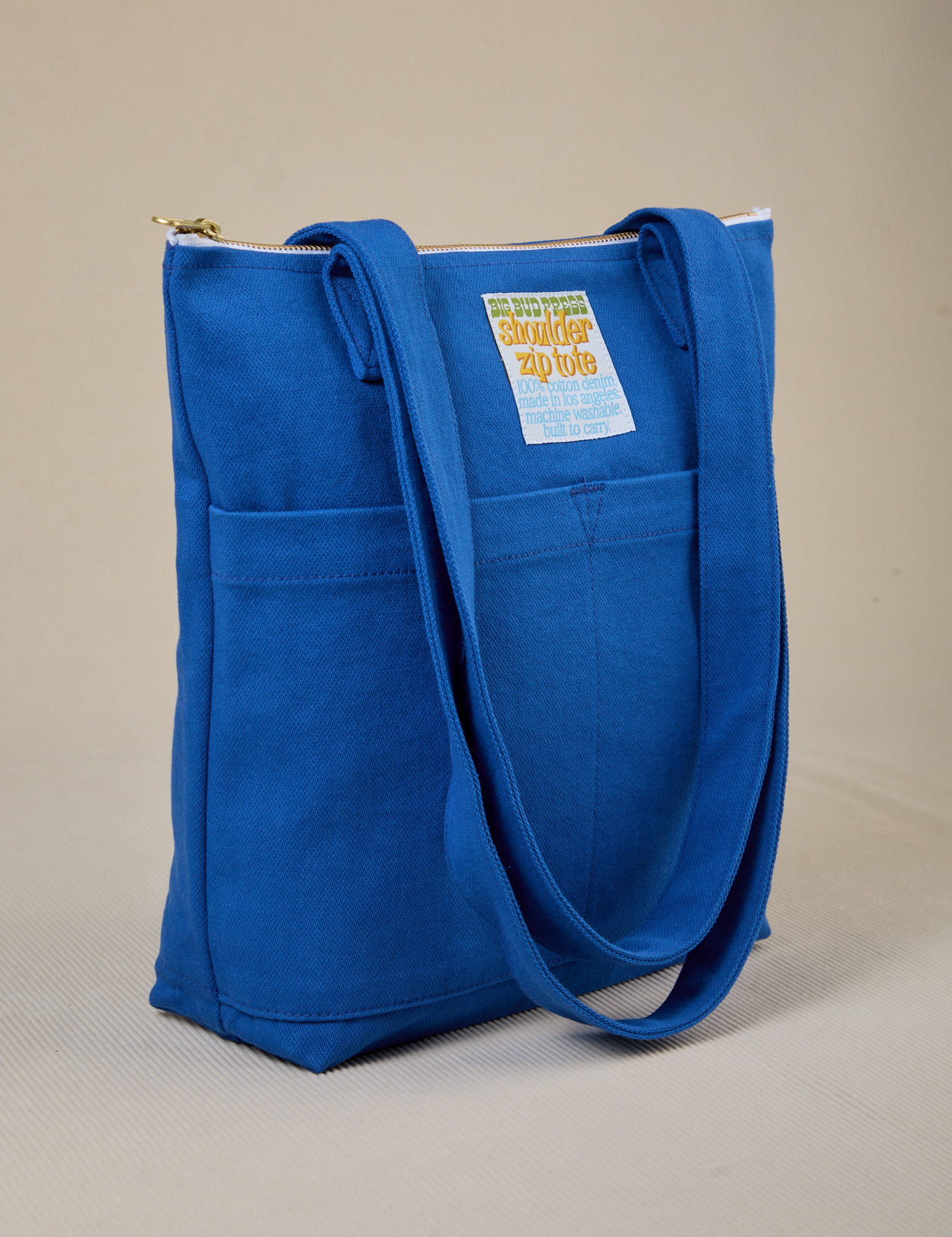 Angled view of Over-Shoulder Zip Mini Tote in Royal Blue